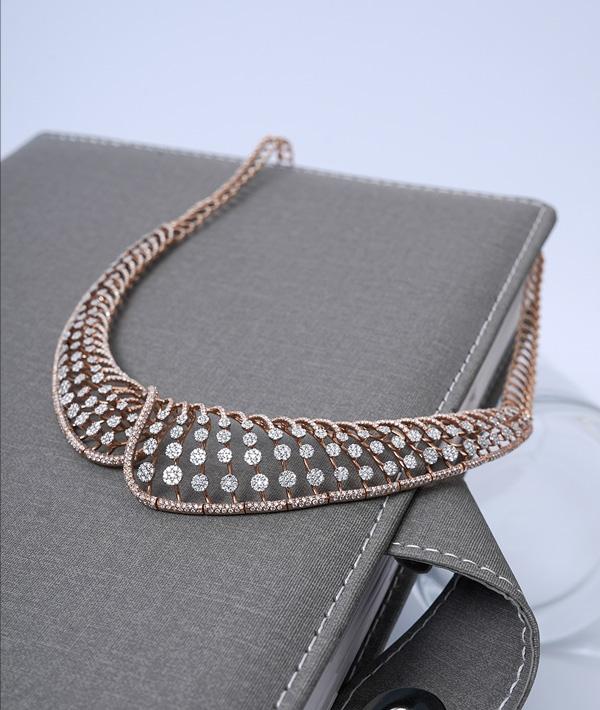 Gold and diamond necklace set on display